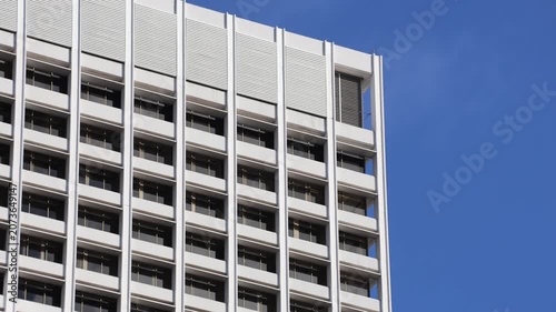 Tall White Office Building Facade Against Blue Sky