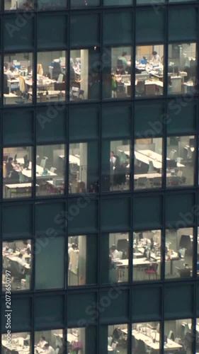 TOKYO, JAPAN : Close up shot of office building window at night. Job, work, company, corporate and business people concept time lapse vertical video.