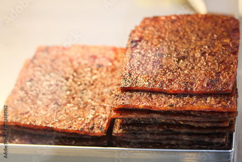 Quadro su tela Two stacks of perfectly charred Bakkwa on display at a stall, a popular Chinese salty-sweet dried meat made from pork