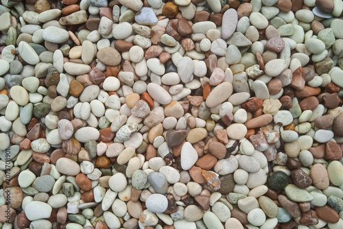 top view of colorful smooth river pebbles texture background