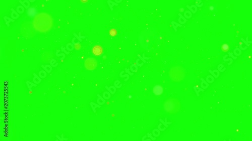Golden particles falling on green screen background