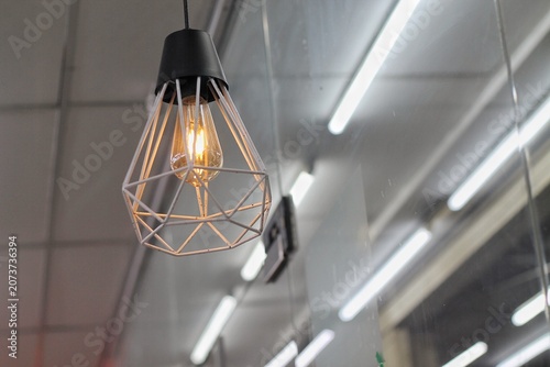 Quadro su tela Warm Edison Bulb in Modern Geometric Pendant Lamp Hanging in Urban Interior Ligh