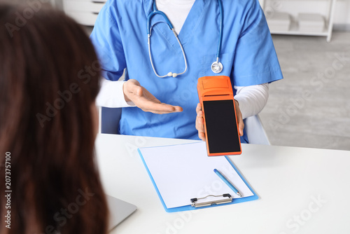 Male doctor with payment te...