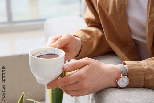 Young woman with white cup ...
