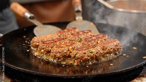 Minced Meat Kebabs Sizzling On Flat Iron Griddle Tawa. 4K Video