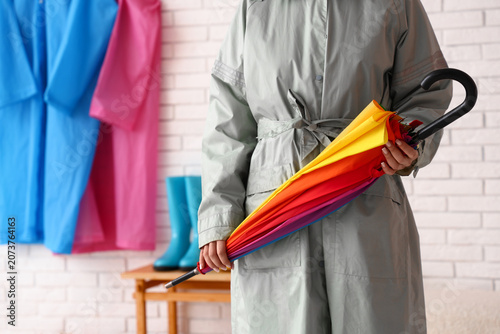 Woman in raincoat with umbr...