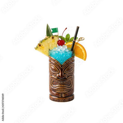 Blue tropical cocktail with umbrella and fruit in a brown tiki glass isolated on transparent background