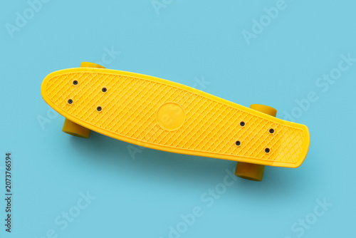 Yellow skateboard on blue b...