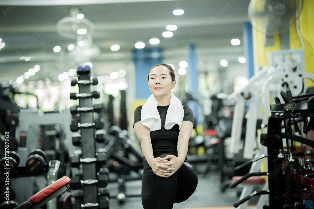 Fototapeta premium Young woman lifting dumbbells in gym, building strength, fitness, confidence, healthy lifestyle, muscular endurance, wellness, and active athletic performance.