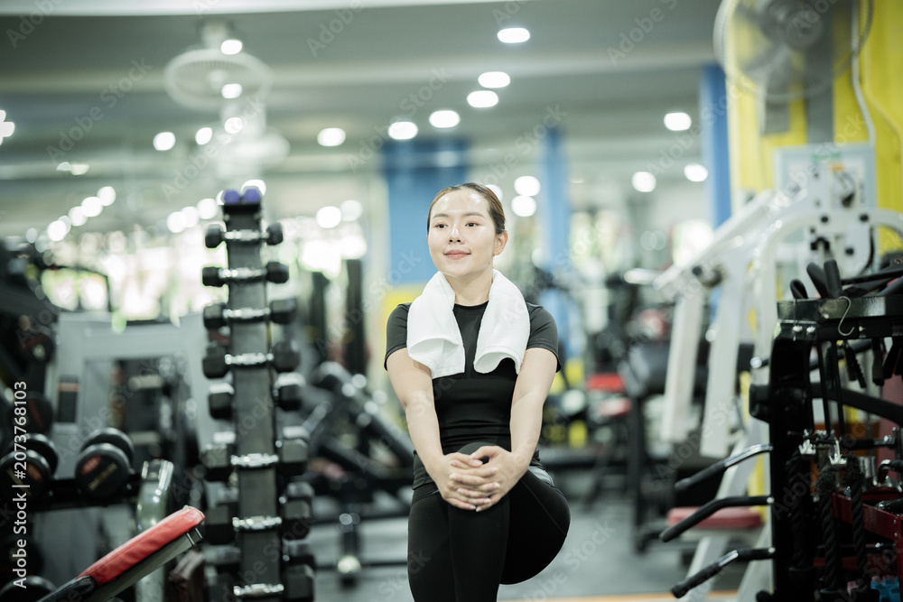 Fototapeta premium Young woman lifting dumbbells in gym, building strength, fitness, confidence, healthy lifestyle, muscular endurance, wellness, and active athletic performance.