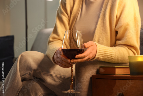 Woman with red wine sitting...