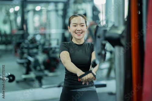 Quadro su tela Young woman lifting dumbbells in gym, building strength, fitness, confidence, healthy lifestyle, muscular endurance, wellness, and active athletic performance