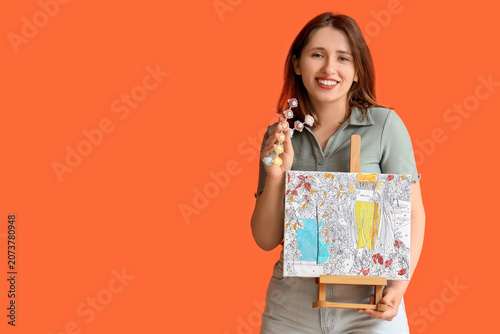 Young woman with painting b...