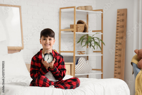 Cute boy in pajamas with al...