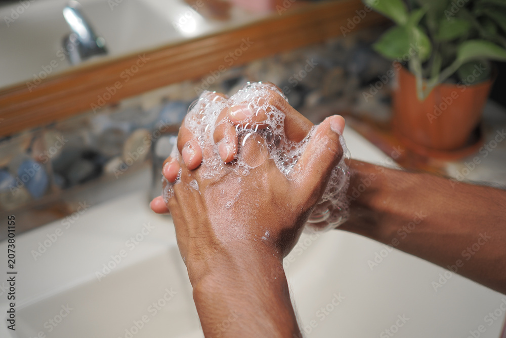 Fototapeta premium Washing hands with soap at a bathroom sink