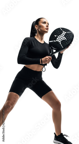 Young athletic caucasian woman, highly muscular, black sportswear, holding padel racket. Dynamic low-angle studio portrait with strong rim lighting on white background. Concept of competitive focus