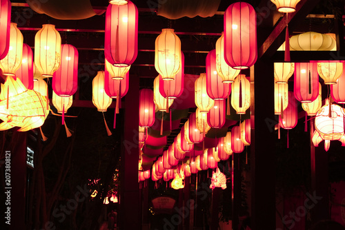 Glowing paper lanterns in a dark corridor