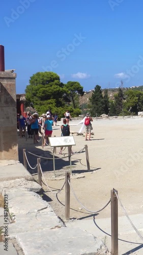 Tourists visiting ruins of Knossos palace in Greece