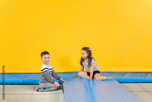 Принти на полотні Happy smiling small kids jumping on indoors trampoline in entertainment center