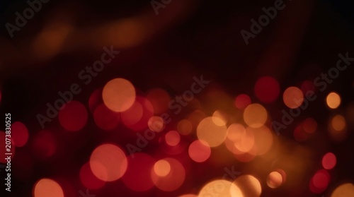 Vibrant orange and red bokeh lights on a dark background for creative design