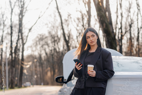 Bild auf Leinwand Woman experiencing car breakdown on roadside using smartphone