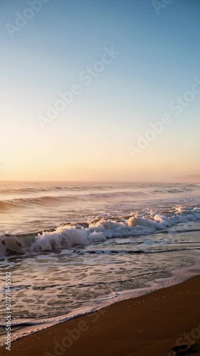 Sunrise Waves Rolling Along Sandy Ocean Shore.