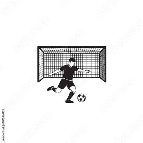Soccer player kicking ball in front of goal net