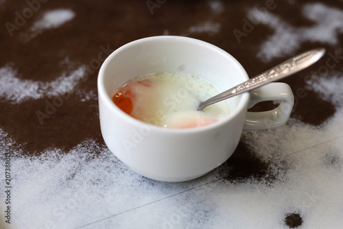 Slika na platnu Soft boiled egg served in a small white ceramic cup with a metal spoon