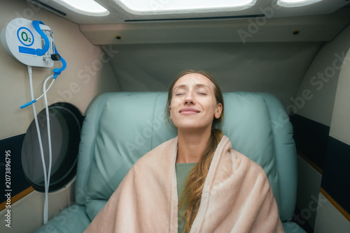 Woman Undergoing Hyperbaric Oxygen Therapy in Modern Wellness Clinic