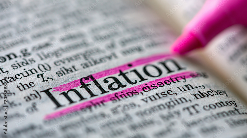 Fototapeta premium Inflation Defined: A dictionary page highlights the word Inflation with a pink highlighter, emphasizing its definition and context.