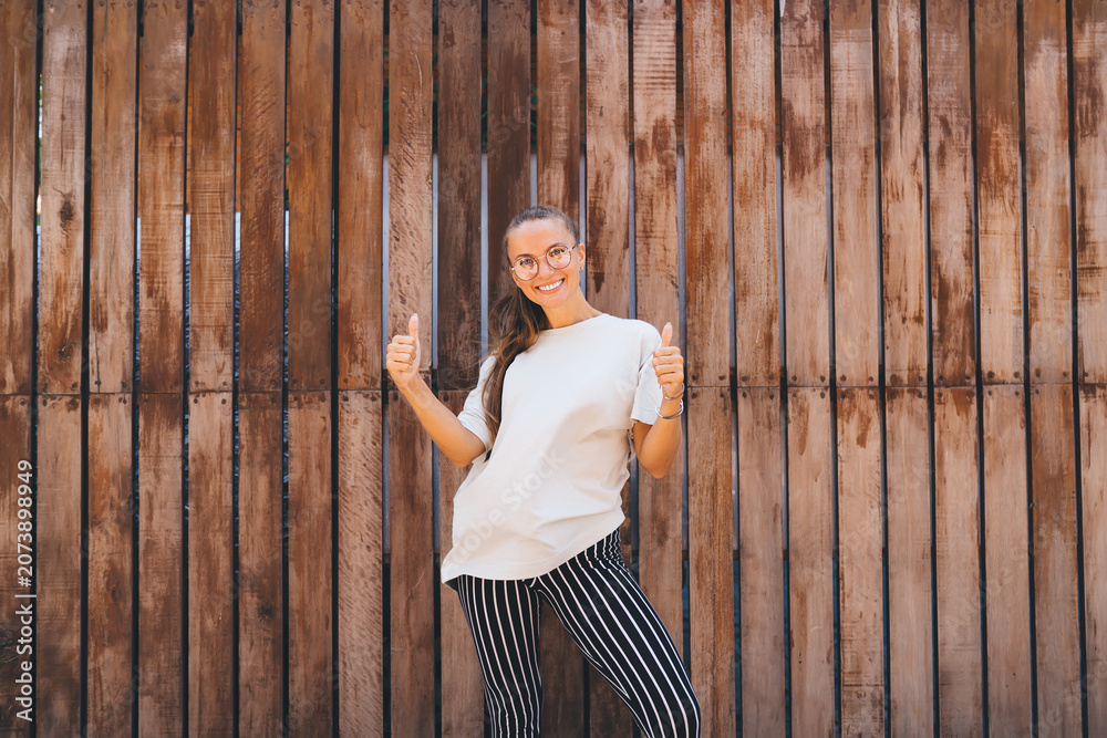 Obraz premium Young Woman Holding a Colorful Skateboard on Urban Stairs with Modern Background