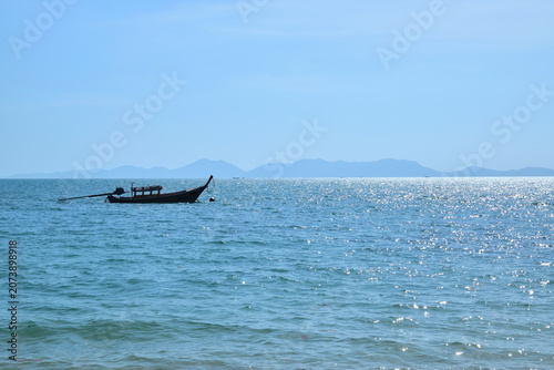 long tail boat with a small motor, Thai  long tail boat on the sea
