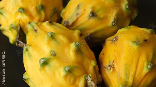 Group of whole raw exotic yellow pitahaya dragon fruits