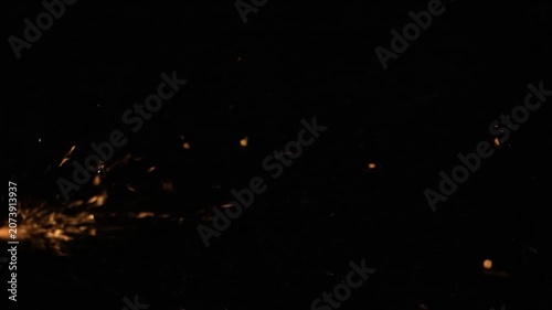 Intense golden sparks flying against a deep black background