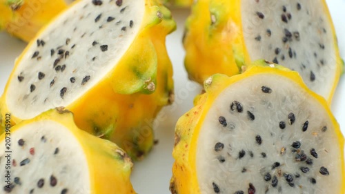 Cut ripe yellow pitahaya fruits close up view.