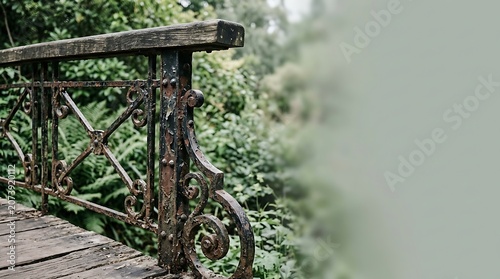Old rusty iron railing of a wooden bridge in a lush green garden