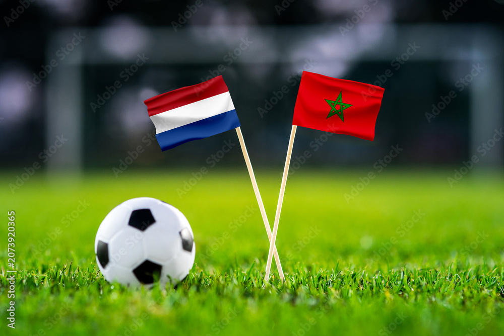 Fototapeta premium Netherlands vs Morocco, national flags before international football tournament Round of 32 match, football on green grass with goal in the background, Guadalupe, Nuevo León, Mexico, June 29, 2026