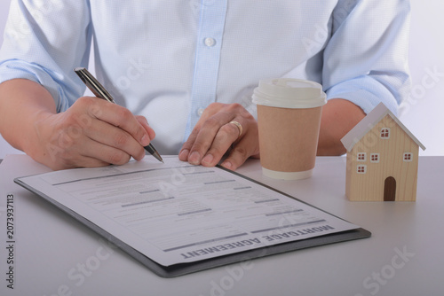 Canvas Print Focused and determined buyer signing real estate contract during successful home