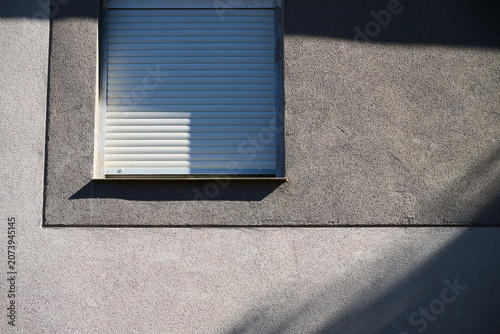 Window of a modern house with the blinds down