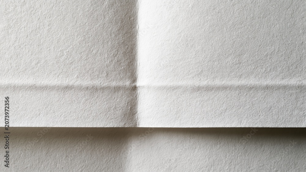 Fototapeta premium Close-up of white textured wall with subtle shadow line