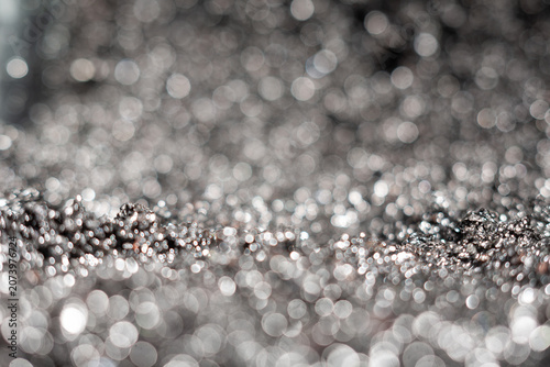 Close-up view of shiny metallic texture with blurred background