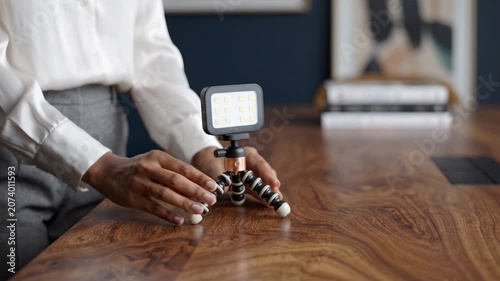 Close-Up of a Luxurious Wooden Desk with a Compact Light Stand, Showcasing the Elegant Grain of the Surface and Minimalistic Office Decor Elements