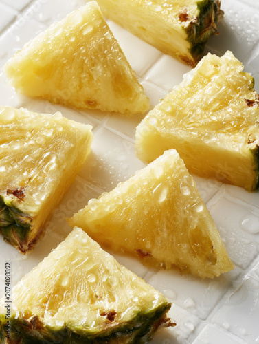 Fresh pineapple slices glisten with dew