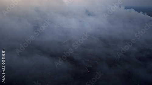 Gray smoke swallows vast sky