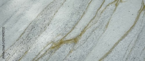 Close-up of naturally formed foam drifting slowly across the water surface, creating unique abstract textures and elegant flowing patterns for creative backgrounds and motion graphics.