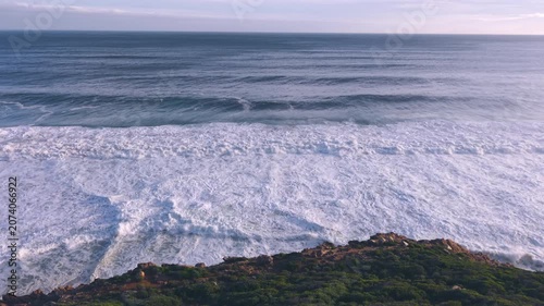 Aerial overhead waves breaking on the coastline