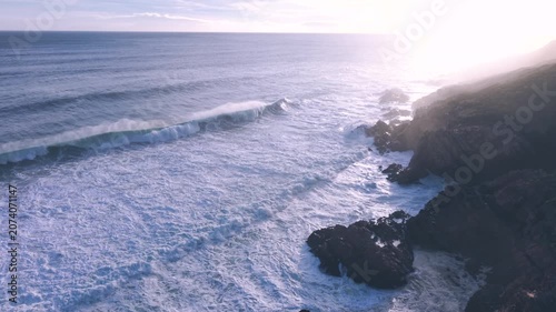 Aerial overhead waves breaking on the coastline
