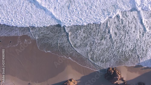 Aerial overhead waves breaking on the coastline