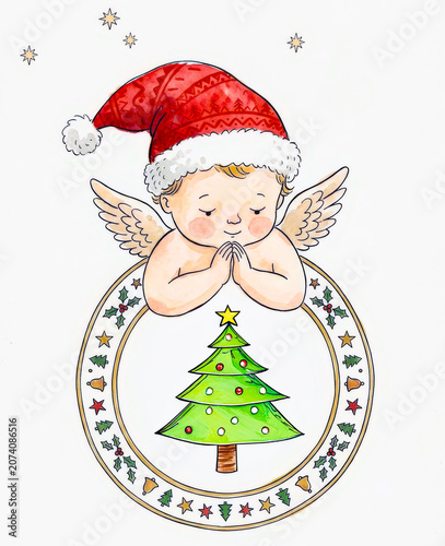 Watercolor drawing of a sweet little christmas angel with wings wearing a red santa hat praying over a decorated green christmas tree inside a circular frame.  Christmas card