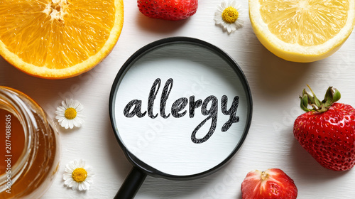 A magnifying glass shows the word allergy surrounded by fruits and honey, providing a clear look at what might cause reactions in some people